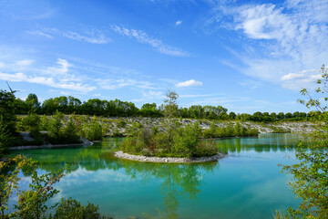 View of the Dyckerhoff lake in Beckum. Quarry west. Blue Lagoon. Landscape with a turquoise blue lake and the surrounding nature.
