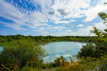 View of the Dyckerhoff lake in Beckum. Quarry west. Blue Lagoon. Landscape with a turquoise blue lake and the surrounding nature.
