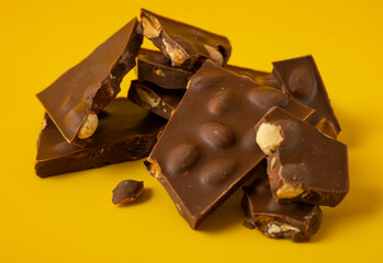 Chocolate with nuts, chocolate pieces close-up.