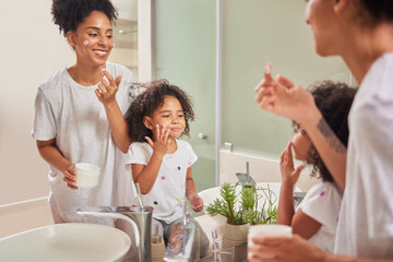 Family, skincare and love with mom and girl with facial product in bathroom mirror together for...