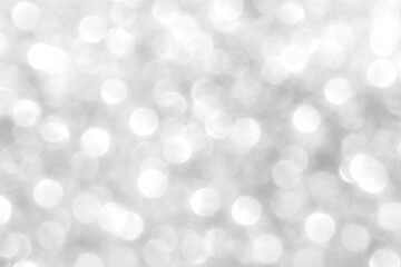 Abstract silver and white bokeh light shiny background. The concept of New Year, Christmas, Wedding anniversary, Winter and all celebration background concepts.	
