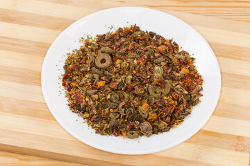 Mixture of spices and dried vegetables on the white dish