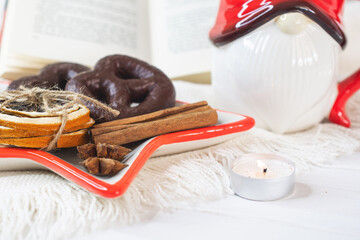 New Year's Eve background, Santa Claus mug with marshmallows, Christmas cookies, open book	