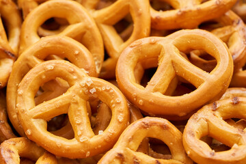 closeup mini salted pretzel in a wooden plate on wood table background.                                                                                                                                