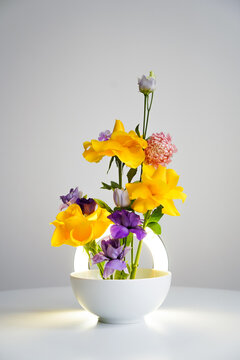 Fresh flowers in a round lamp, illumination of natural decor in the interior
