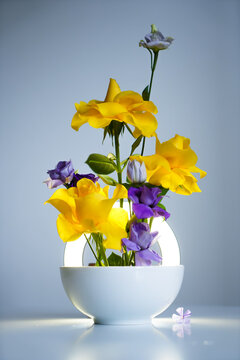 A beautiful composition of fresh flowers on the table in original light