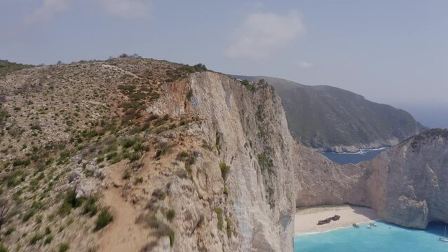 Aerial - Shipwreck in Zakynthos - low pass from rocks and tilting down