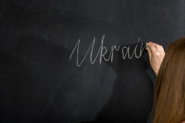 a girl writes the word 