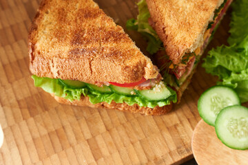 Fried sandwiches in close-up on a wooden background. The concept is breakfast.
