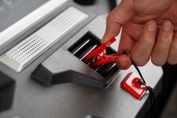 Mature Asian man on treadmill with emergency stop line in one hand.