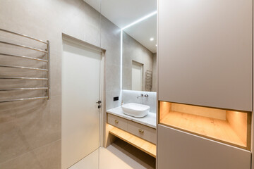 Obraz na płótnie Canvas bathroom interior design with large mirror gray tiles and glass wall