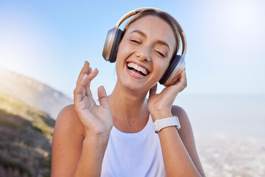 Smile, Laughing And Hiking Woman With Headphones In Fun Exercise, Fitness Or Workout In Countryside Mountains. Happy, Face And Comic Athlete Listening To Music, Radio Or Funny Audio Podcast In Nature