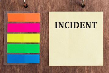 Medical and healthcare concept. Incident text on a yellow card on a wooden background next to...