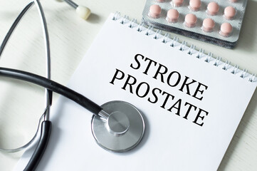 Stroke PROSTATE text on the notebook next to it is a stethoscope and tablets. Medical concept.