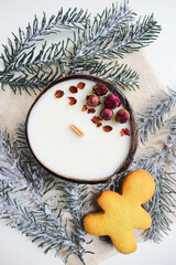 Fototapeta na wymiar original christmas candle in coconut and fir branches 