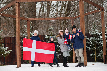 Family with Denmark flags outdoor in winter. Travel to Scandinavian countries. Happiest danish people's .