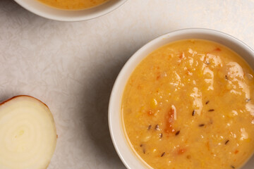 Homemade yellow split pea lentil soup served in a bowl. Arhar dal. View from above.