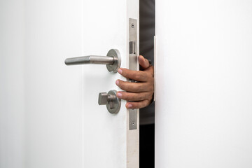 Hand clamped door. A young man shut the door of the house so carelessly and clumsily that the door...