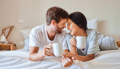 Love, happy and a couple with coffee in bed on beautiful morning at home. Weekend, wake up and...