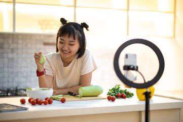 Cheerful cooking vlogger live-streaming her video blog to followers