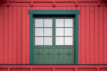 Colorful symmetric wooden window on a wall