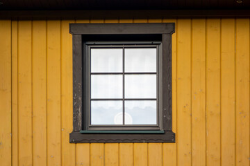 Colorful symmetric wooden window on a wall