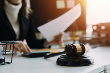 Male lawyer working with contract papers and wooden gavel on tabel in courtroom. justice and law...