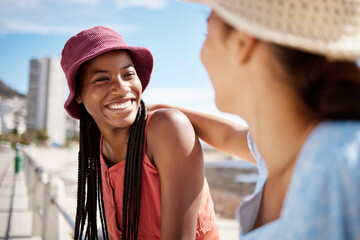 Black woman friends at the beach in an urban city for summer, vacation or holiday with sunshine in...