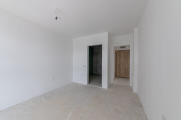 New empty room under construction. Plaster walls. New home. Concrete walls. Interior renovation.