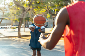 One vs one basketball game training at the court. Cinematic look image of friends practicing shots...
