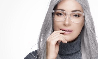 Stylish silver haired woman wearing eyeglasses. Optic eyewear, clear vision and eyecare concept. Head shot studio portrait on white background with copy space