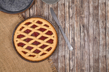 Top view of homemade pie called 'Linzer Torte', a traditional Austrian shortcake pastry topped with fruit preserves and ground nuts with lattice design