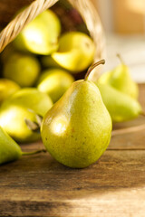 Pears on a wooden background. Fruit harvest. Autumn still life. Pear variety Bera Conference.