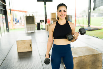 Cheerful fitness woman enjoying her workout at the gym