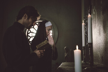 Nun and priest praying and spending time in the monastery