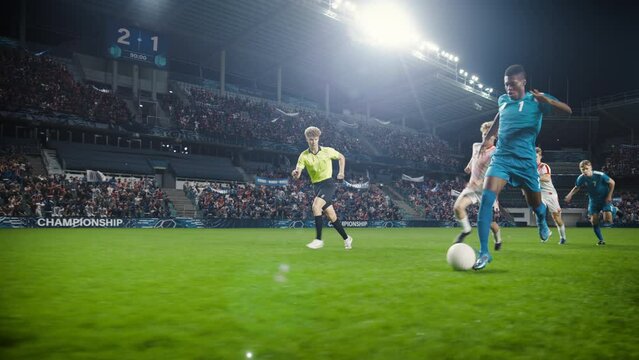 Professional Soccer Football Match Championship: Blue Team Attacks, Black Forward Masterfully Dribbles on an International Tournament. Stadium of Fans Cheers. Cinematic Playback in Slow Motion