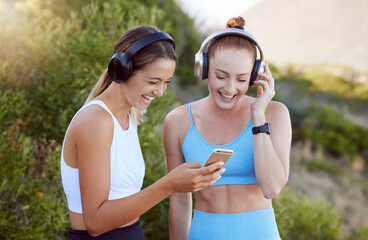 Headphones, phone and fitness women in nature music, radio or audio streaming during exercise. Health, wellness and happy athlete girls on mobile, social media or 5g tech, workout app and training.