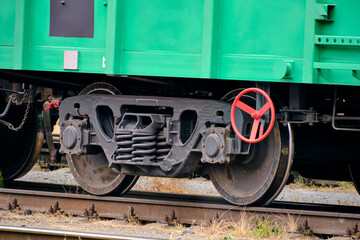 Naklejka premium Steel wheelset of railway cars on rails.