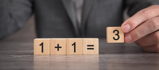 1+1=3 on wooden cubes. Synergy