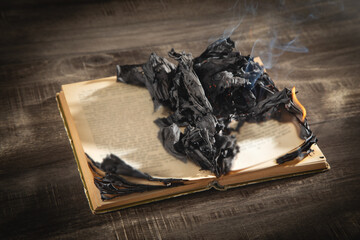 Burning book on the wooden table.
