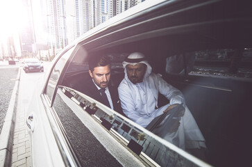 Business team talking about future plans in Dubai in the limousine