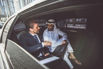 Business team talking about future plans in Dubai in the limousine