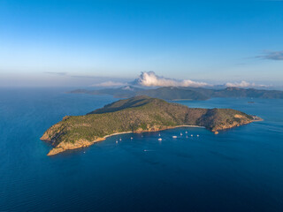 Evening aerial drone view of Hayman Island, the most northerly of the Whitsunday Islands in Queensland, Australia, near the Great Barrier Reef. Blue Pearl Bay in foreground, Hook Island in the back.