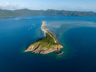 Stunning aerial high angle view of Langford Island with a long spit and Hook Island in the background, both part of the Whitsunday Islands group near the Great Barrier Reef in Queensland, Australia.
