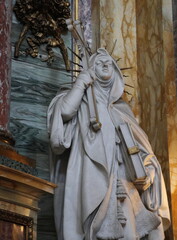 Statue of a Woman Holding a Cross and a Book Depicting Religion at the Santi Ambrogio e Carlo Basilica in Rome, Italy