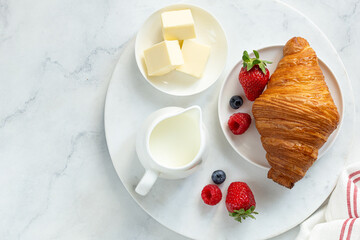 Freshly baking croissant with fresh berries