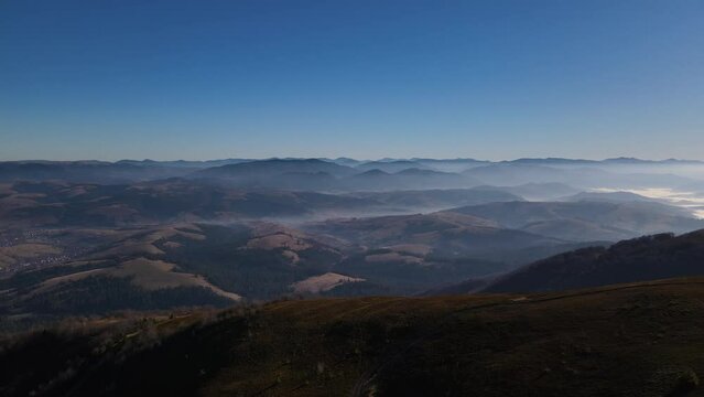Drone flies high up over mount, scenic aerial landscape of Carpathian mountains in early autumn