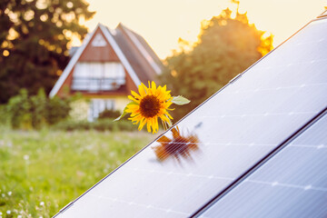 Small solar energy farm in countryside, next to a small household home. Renewable energy concept....