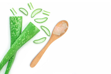 Aloe vera gel in wooden spoon and aloevera plant isolated on white background. Top view. Copy space.