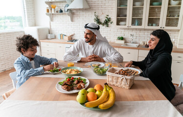 happy family from emirates eating together